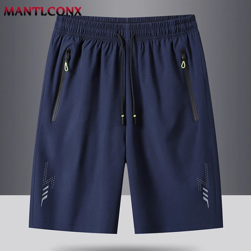 Navy blue shorts with zippers on a gray background, featuring the brand 'MANTLCONX'.