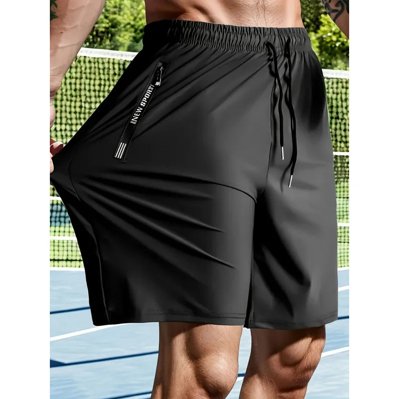 Black athletic shorts with a brand logo on a tennis court background