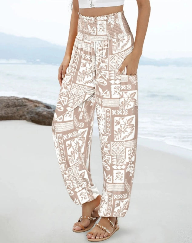 Person wearing white patterned pants on a beach