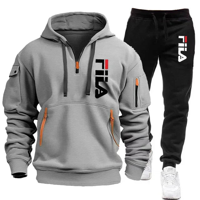 Gray hoodie and black pants with Fila logo on a white background