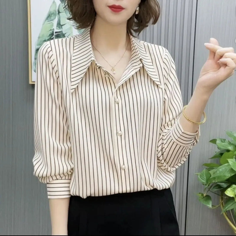 Woman wearing a striped blouse with a neutral background