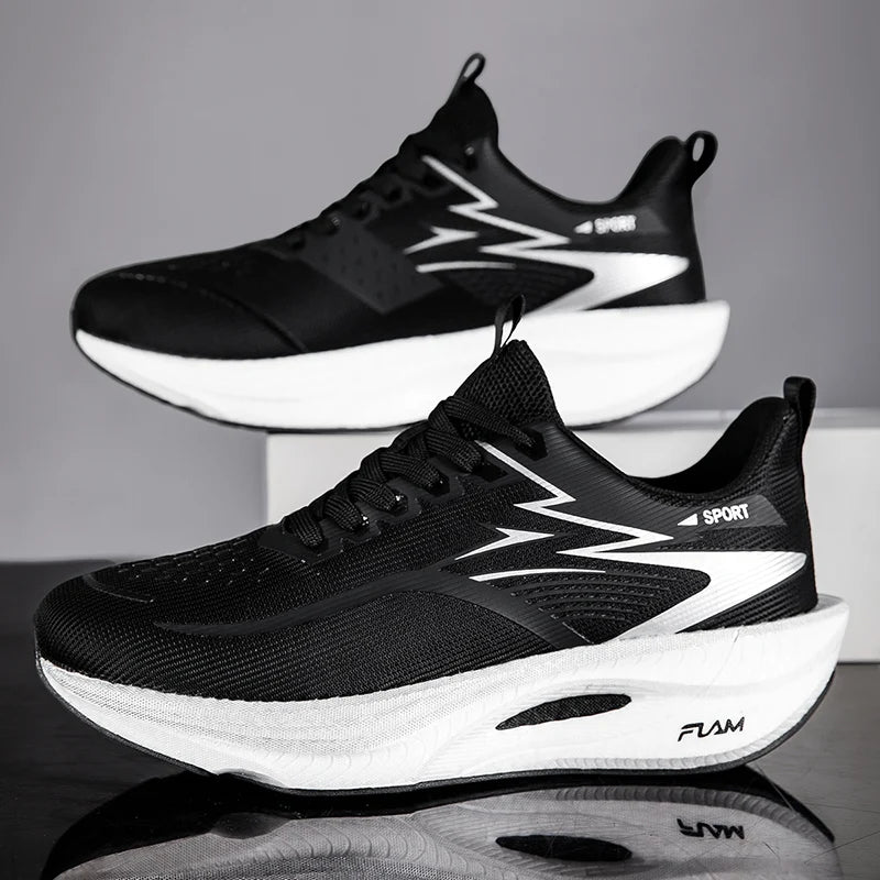 Black and white athletic shoes with visible branding on a reflective surface.