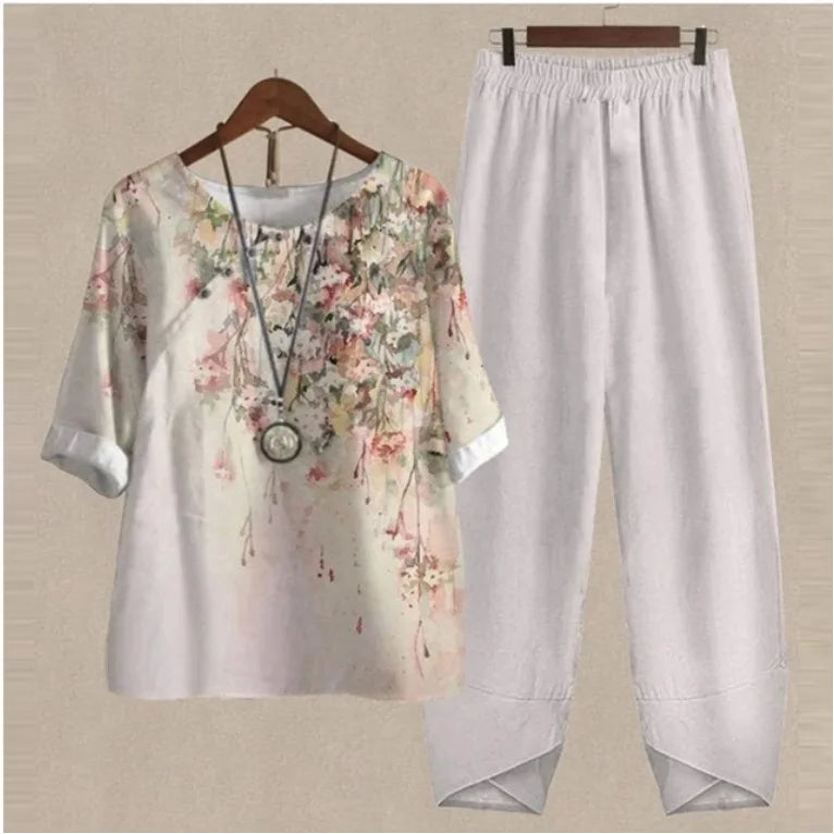 Floral blouse and white pants on a beige background