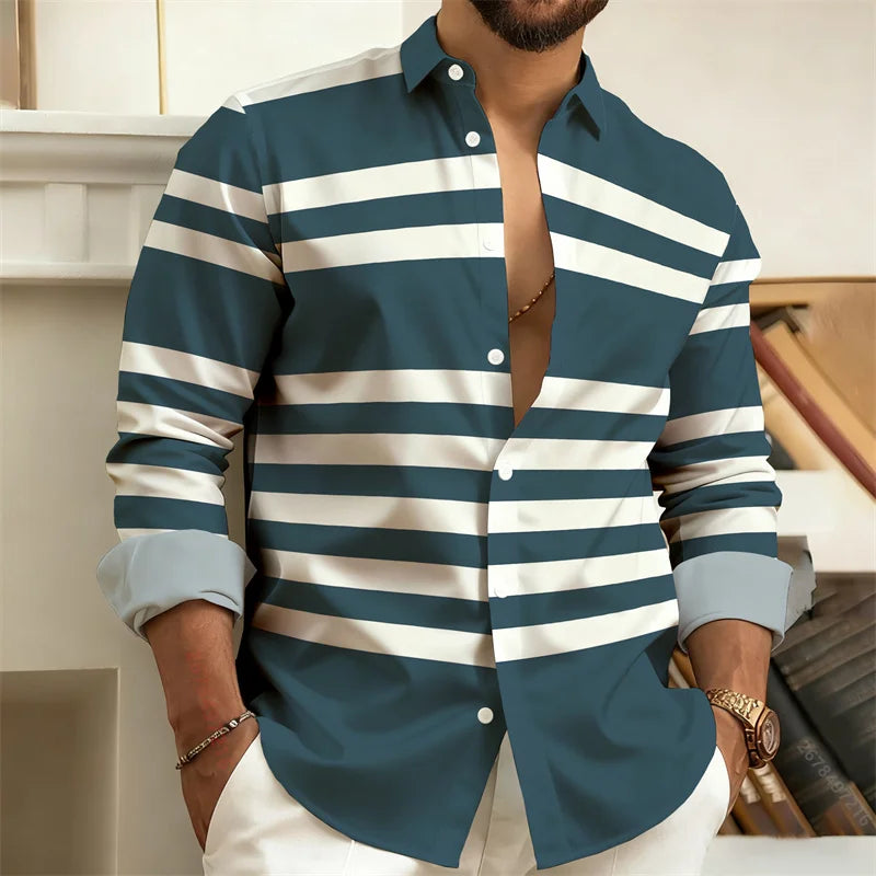Man wearing a blue and white striped shirt with rolled-up sleeves, standing indoors.