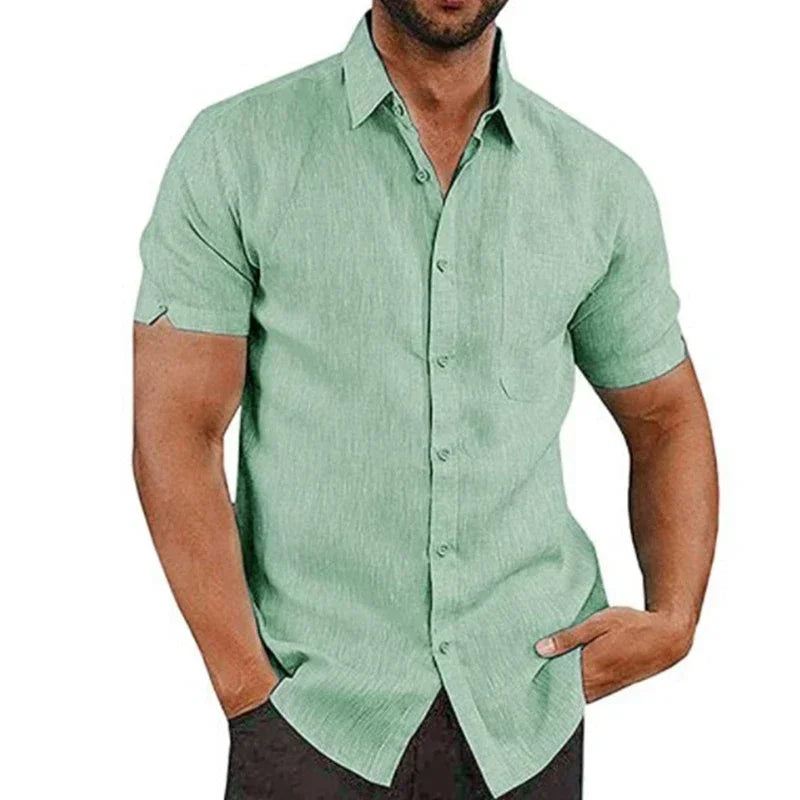Green short-sleeve shirt worn by a person on a white background