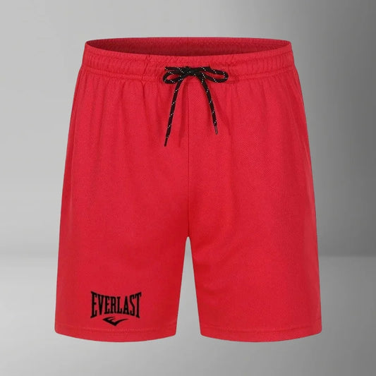 Red shorts with a black drawstring and 'Everlast' logo on a gray background