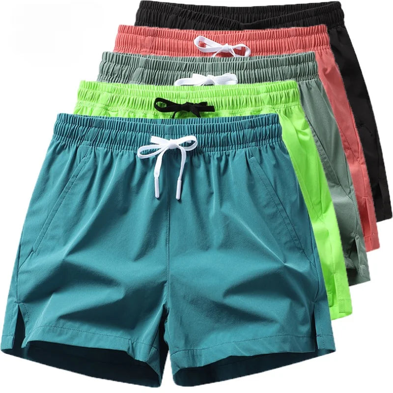Set of colorful shorts including teal, green, red, and black on a white background