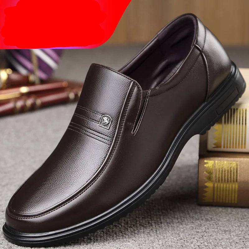 Brown leather shoe on a textured surface with books and stationery items.