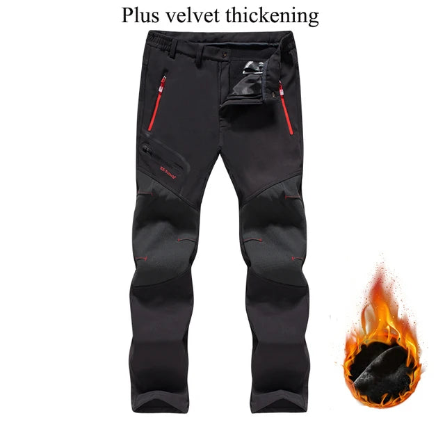 Black pants with red zippers on a white background, featuring text 'Plus velvet thickening' and an illustration of flames.