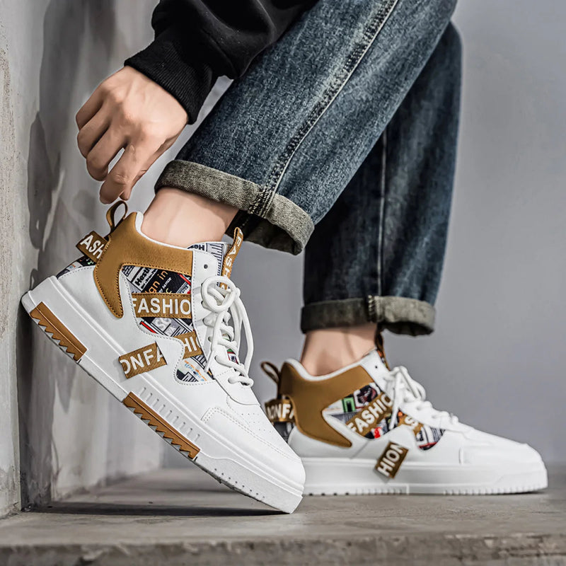 White sneakers with brown accents worn by a person sitting on a wooden floor.