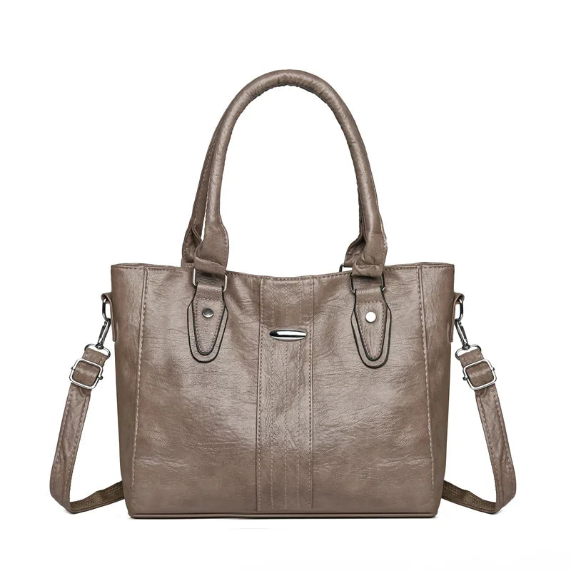 Brown handbag with a shoulder strap on a white background