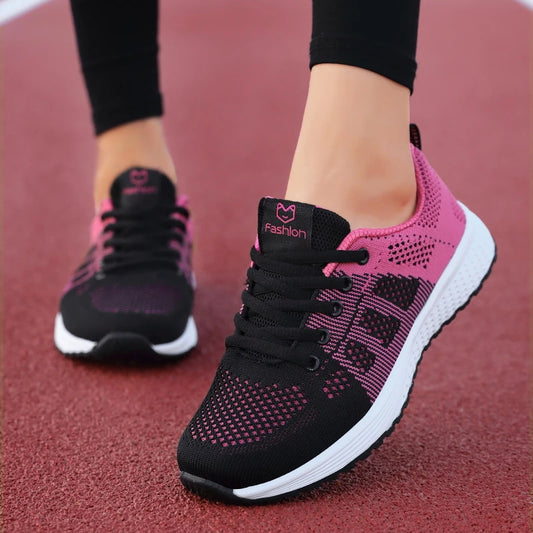 Black and pink sneakers on a red surface