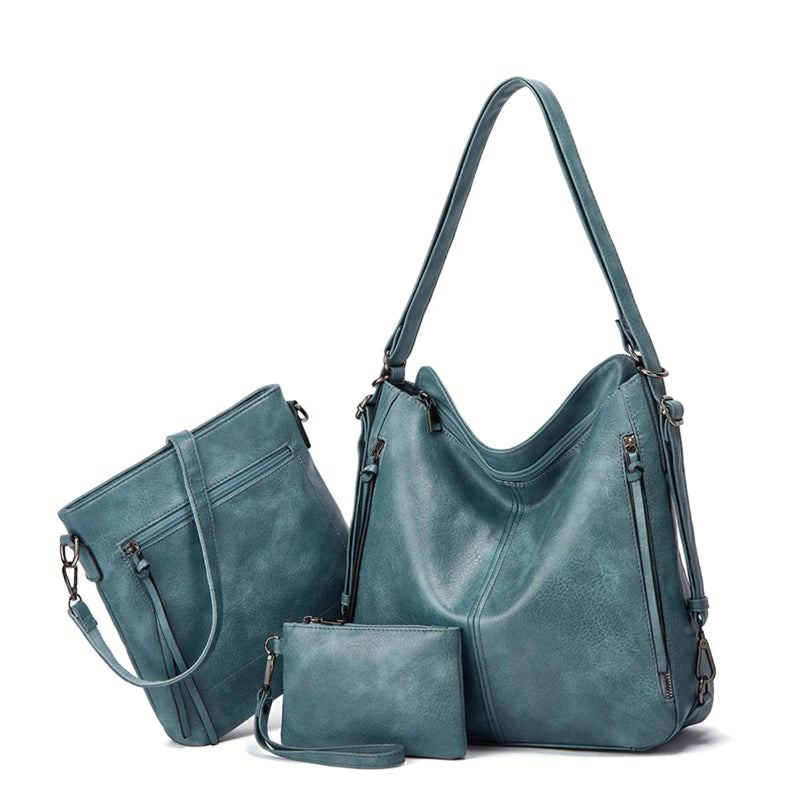 Set of teal handbags including a large shoulder bag, smaller handbag, and matching wallet on a white background.