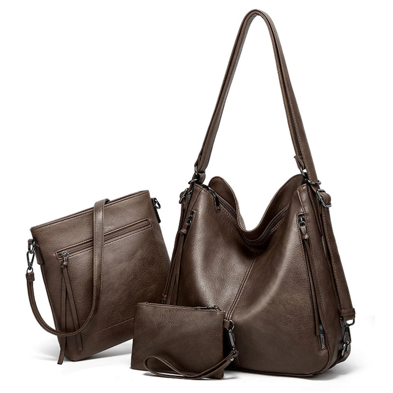 Brown leather handbag with matching smaller pouch on a white background