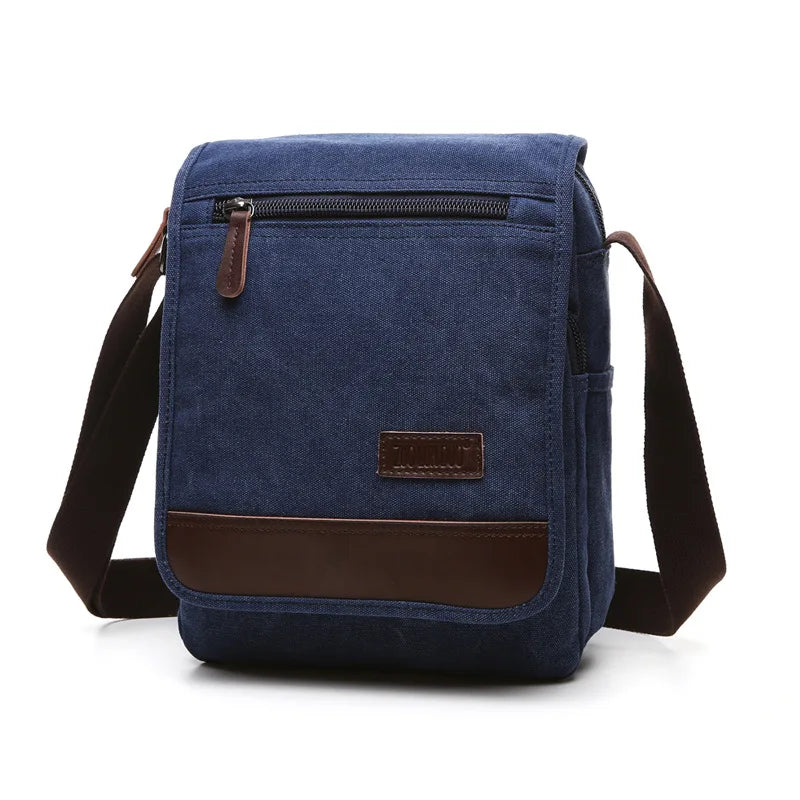 Blue canvas crossbody bag with brown accents on a white background
