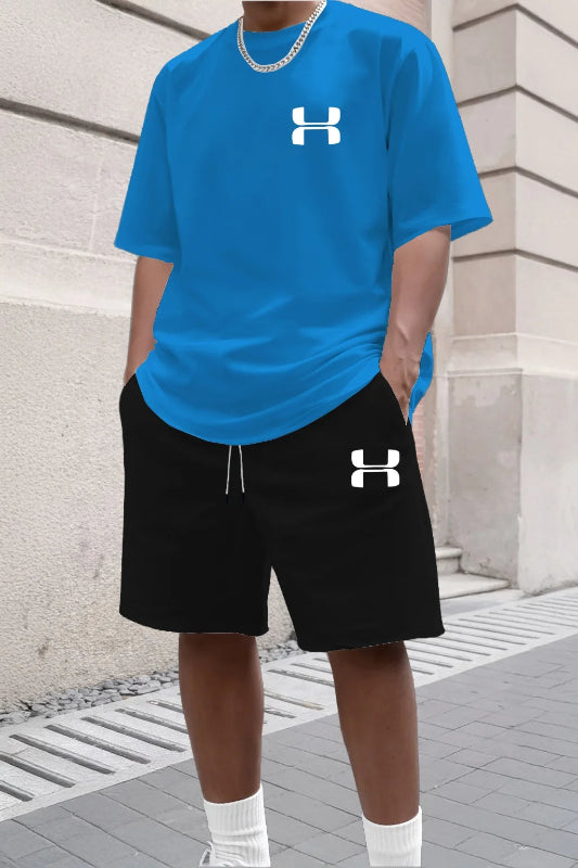 Person wearing a blue Under Armour t-shirt and black shorts with the brand logo.