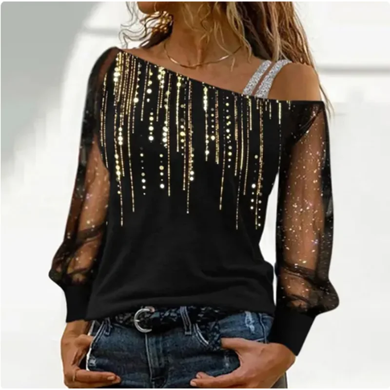 Black off-shoulder top with gold embellishments worn by a person.