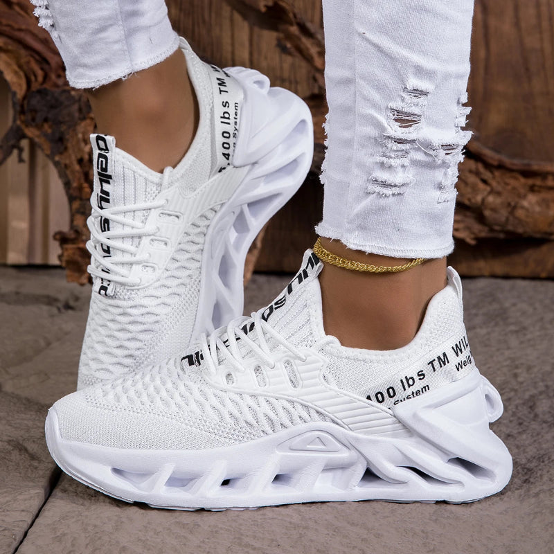 White sneakers with text on a neutral background
