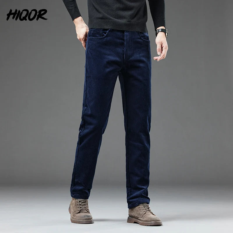 Person wearing dark blue pants and brown boots on a gray background with 'HIQOR' branding.