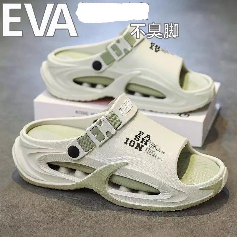 White sandals with green accents on a gray surface, featuring brand name and text.