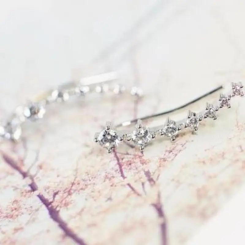 Silver hairpin with small diamonds on a soft pink background