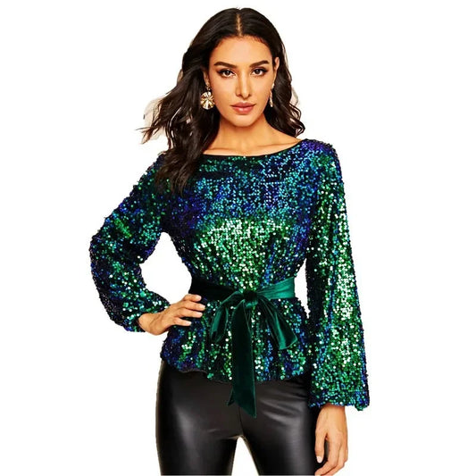 Woman wearing a green sequin top with a belt on a white background