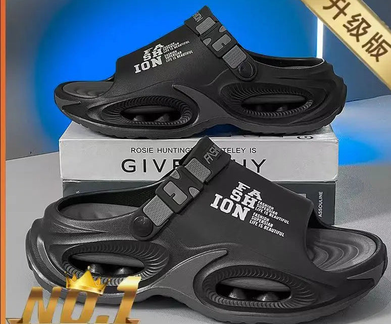Black sandals with branding on a gray surface and blue background