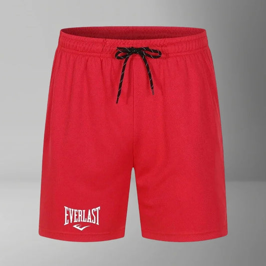 Red shorts with a black drawstring on a gray background