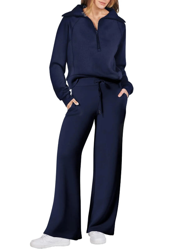 Navy tracksuit worn by a person on a white background