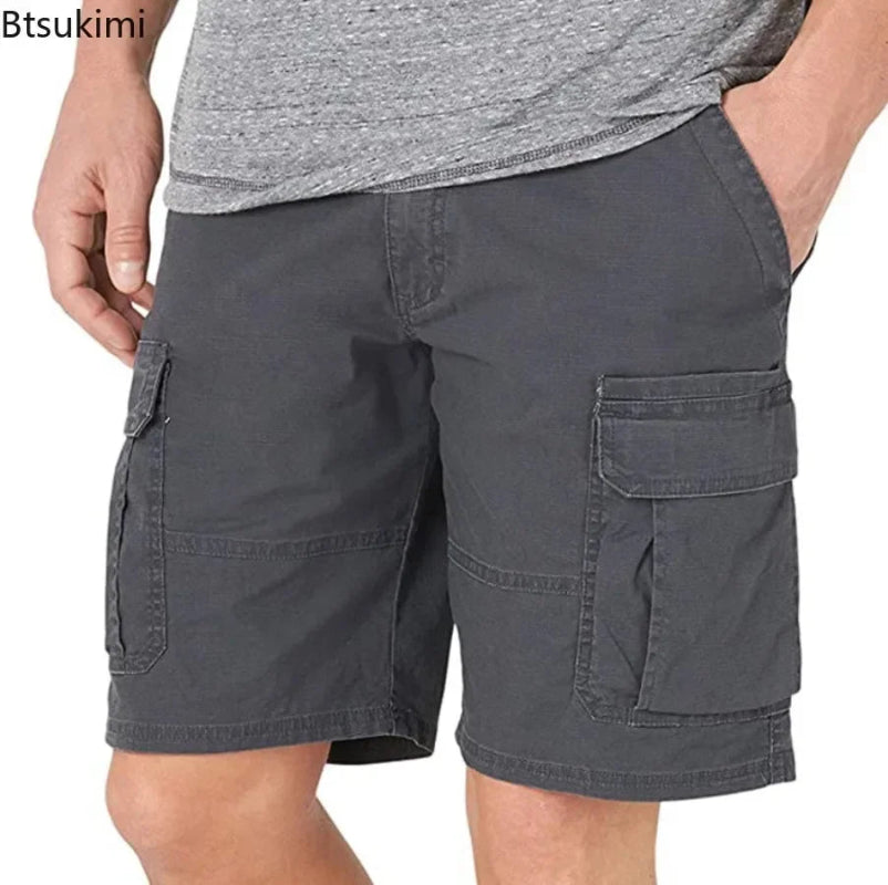 Person wearing gray cargo shorts on a white background
