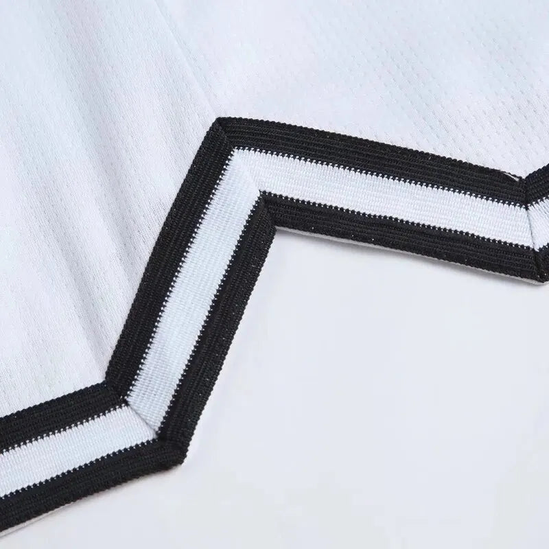 Close-up of a black and white striped fabric border on a light background