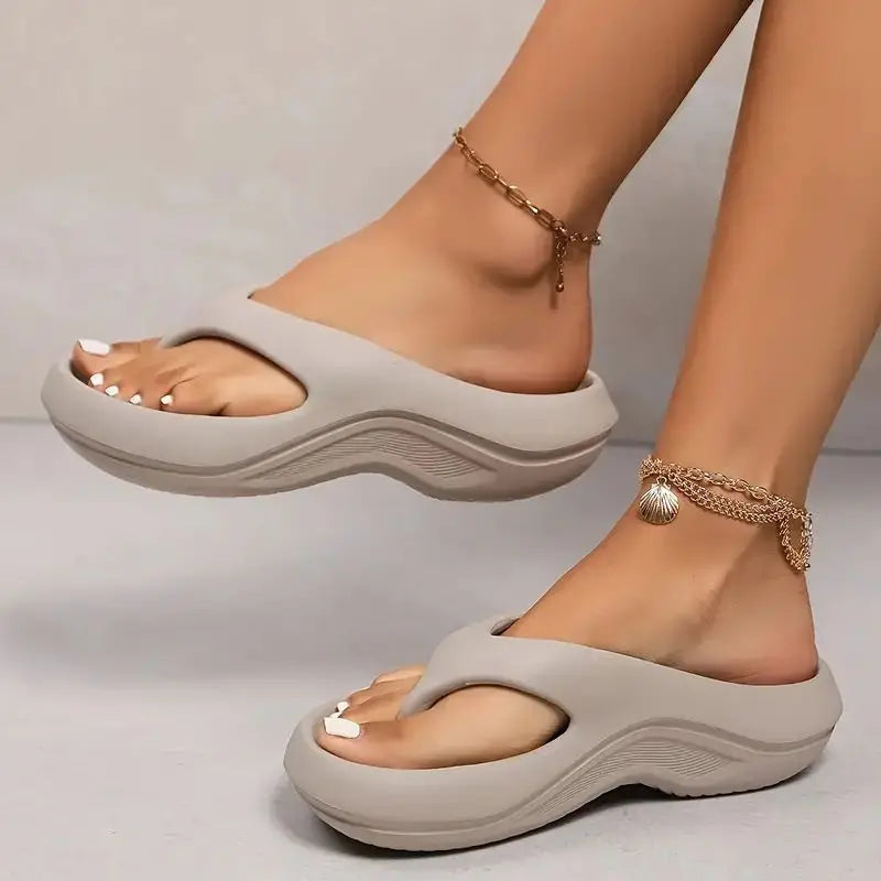Light gray sandals worn on feet with a neutral background