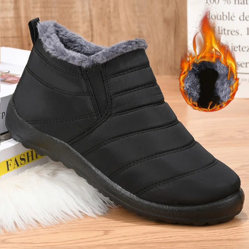 Black winter boot with gray fur lining on a wooden surface