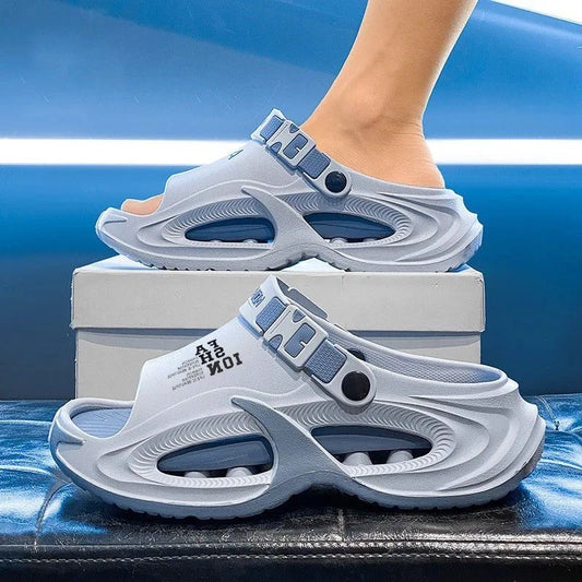 Gray sandals with blue accents worn by a person on a blue background
