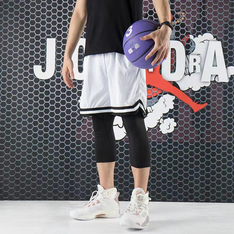 Person holding a purple basketball in front of a branded background