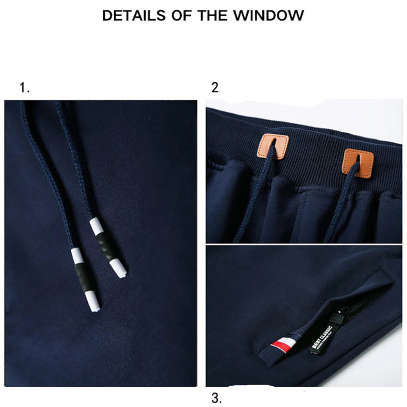 Navy blue jacket with drawstring, patch details, and zipper pocket on a white background.