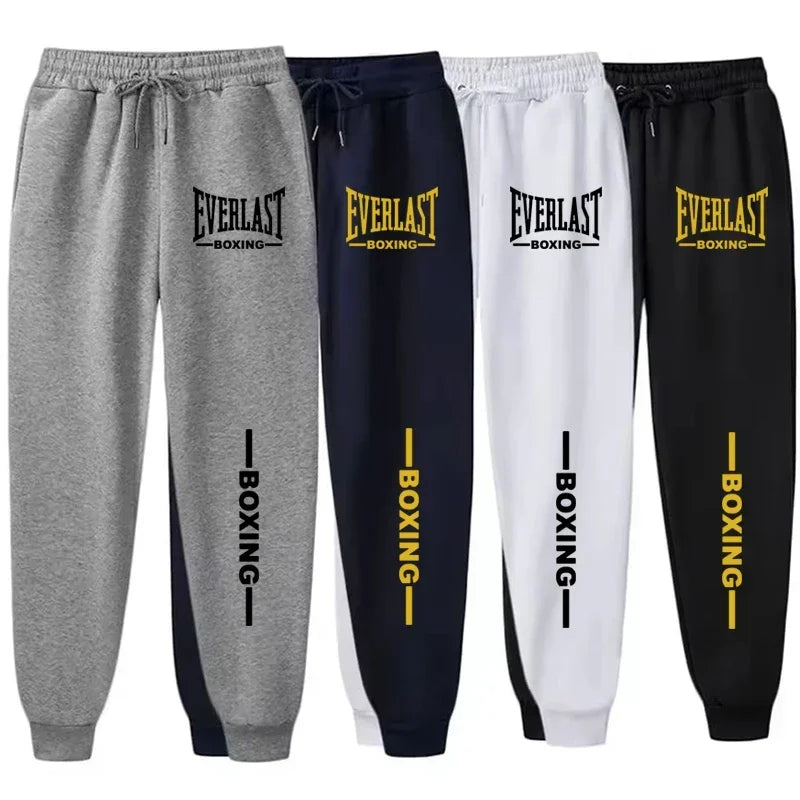 Four pairs of Everlast boxing sweatpants in gray, navy, white, and black with yellow and black text.