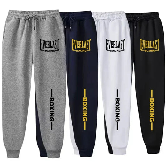 Four pairs of Everlast boxing sweatpants in gray, navy, white, and black with yellow and black text.