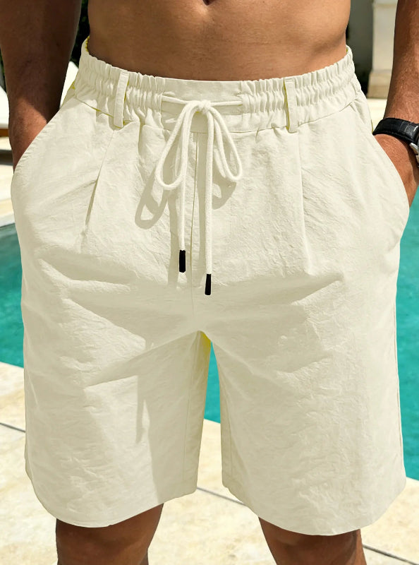 White shorts with a drawstring worn by a person by a pool.