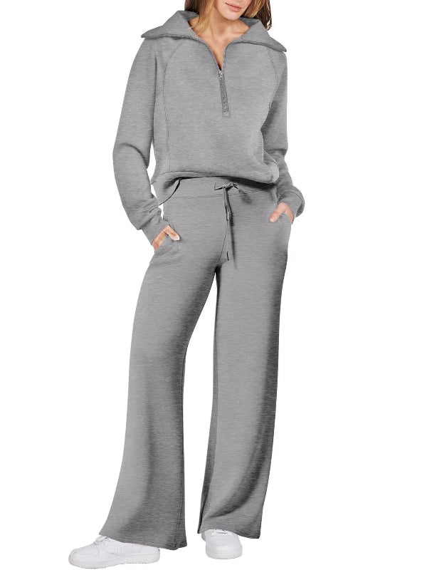 Gray tracksuit worn by a person on a white background
