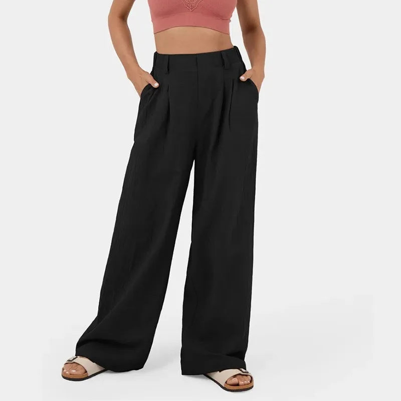 Person wearing black wide-leg pants on a white background