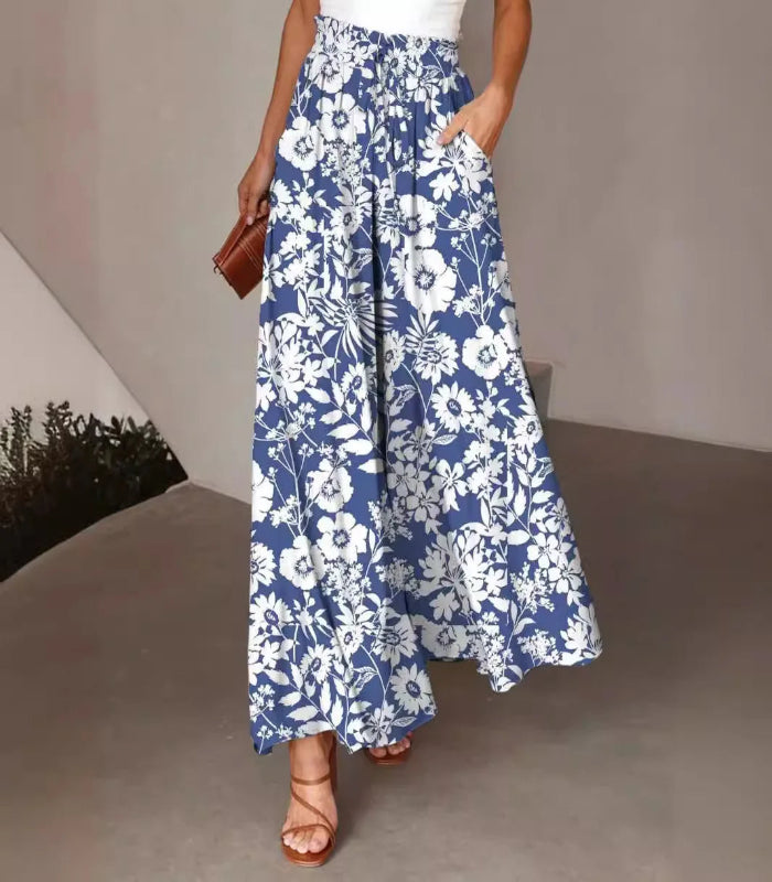 Person wearing a blue floral dress with a plain background