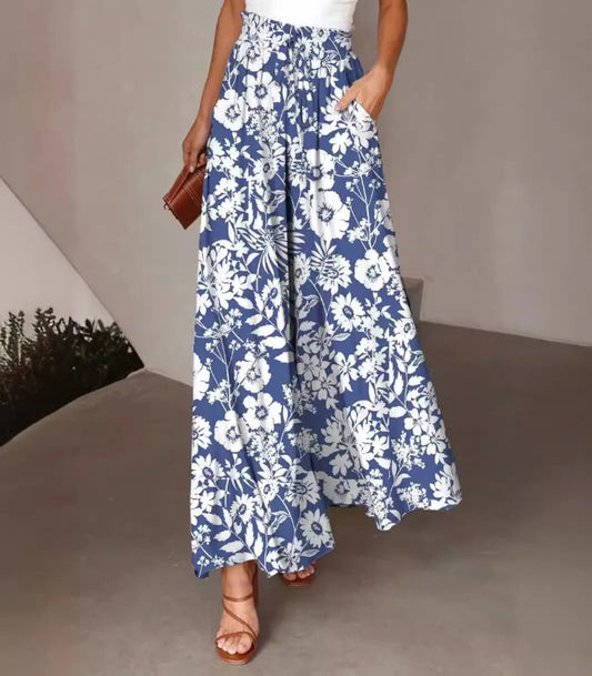 Person wearing a blue floral dress with a plain background