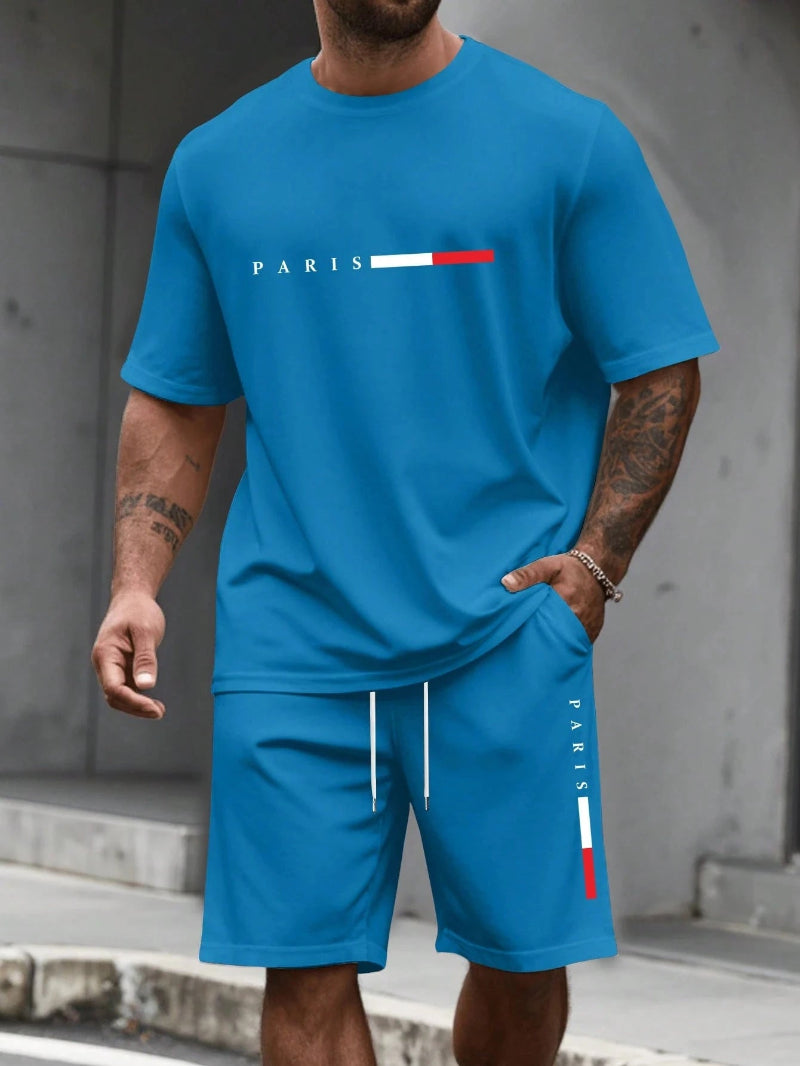 Person wearing a blue t-shirt and shorts set with 'PARIS' and flag design.