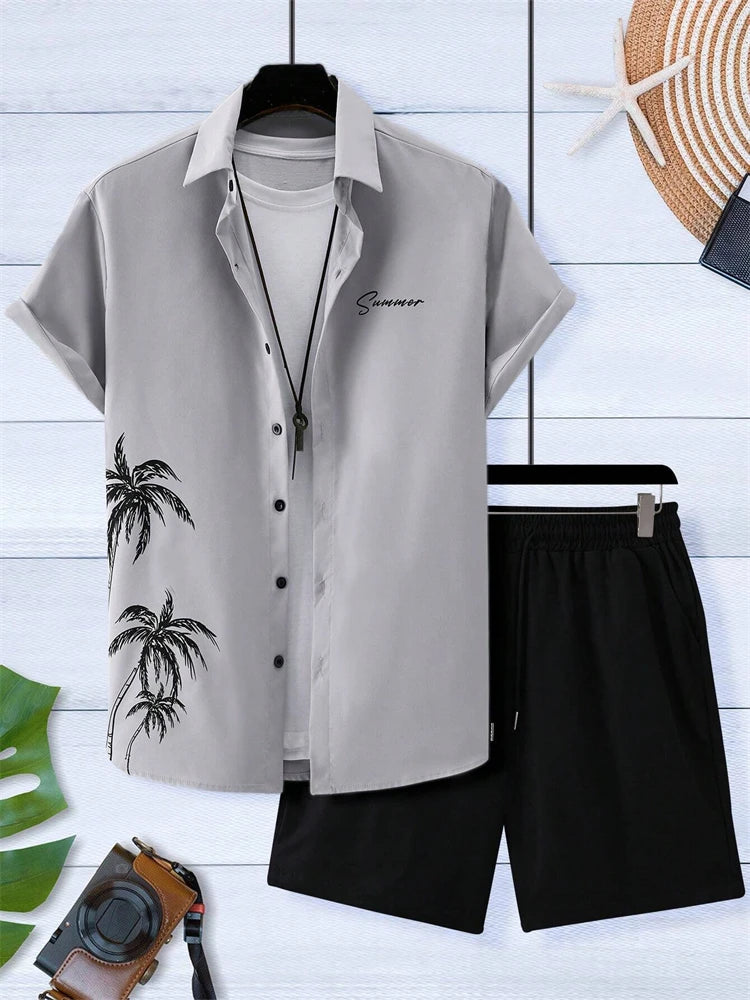 Gray shirt with palm tree design and black shorts on a white wooden floor.