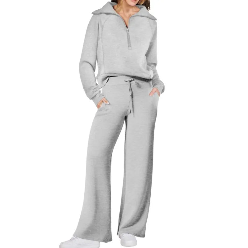 Gray tracksuit worn by a person on a white background