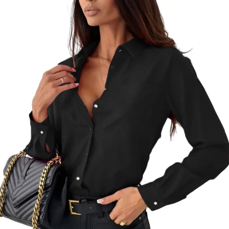 Woman wearing a black button-up shirt with a gray handbag on a white background