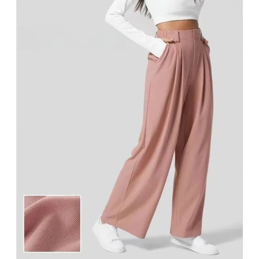 Pink wide-leg pants worn by a person on a light gray background
