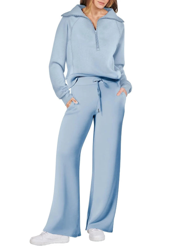 Light blue tracksuit worn by a person on a white background