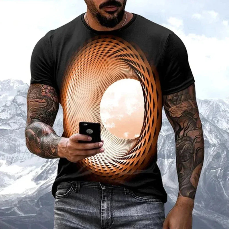 Man wearing a black t-shirt with a geometric design, holding a phone with a mountainous background.